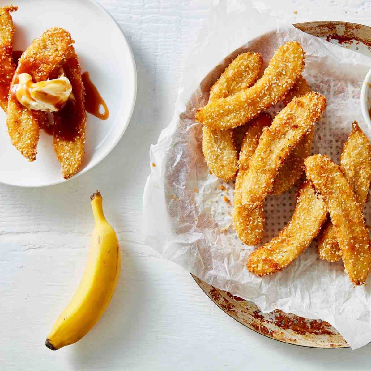 Air fryer little gem banana fritters in a bowl, with a banana next to them.