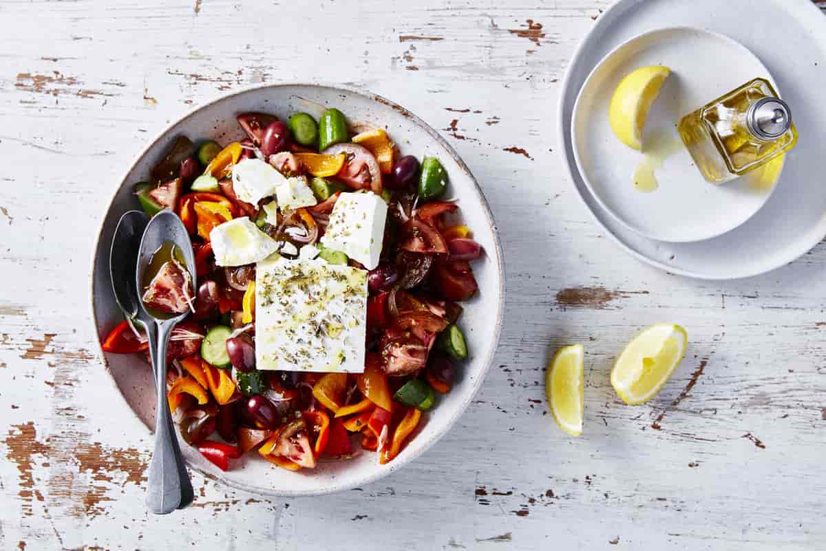 Perfection Greek Salad with Kumato, Qukes and Feta in a bowl.