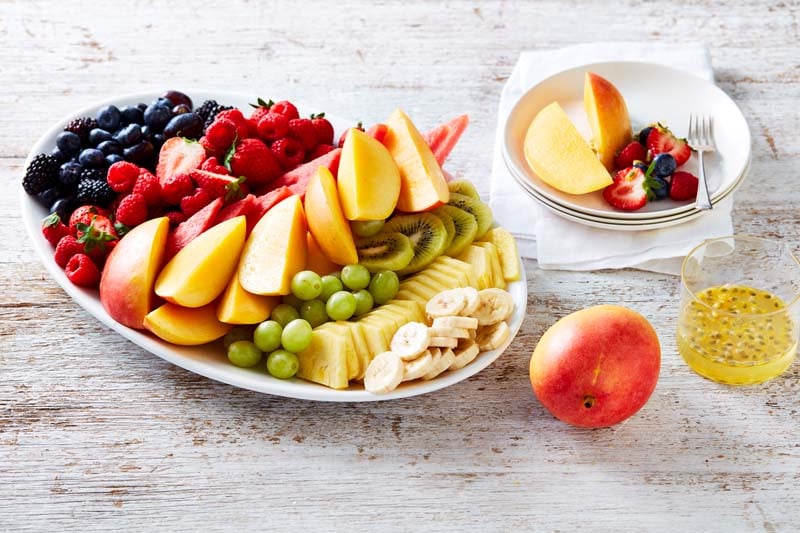 Fruit platter with passionfruit syrup.