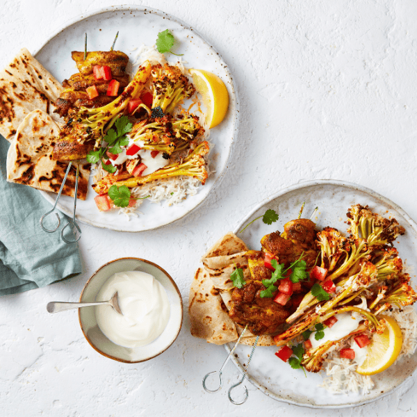 Tandoori roasted Cauli-blossom with lemon and flat bread on a plate. 