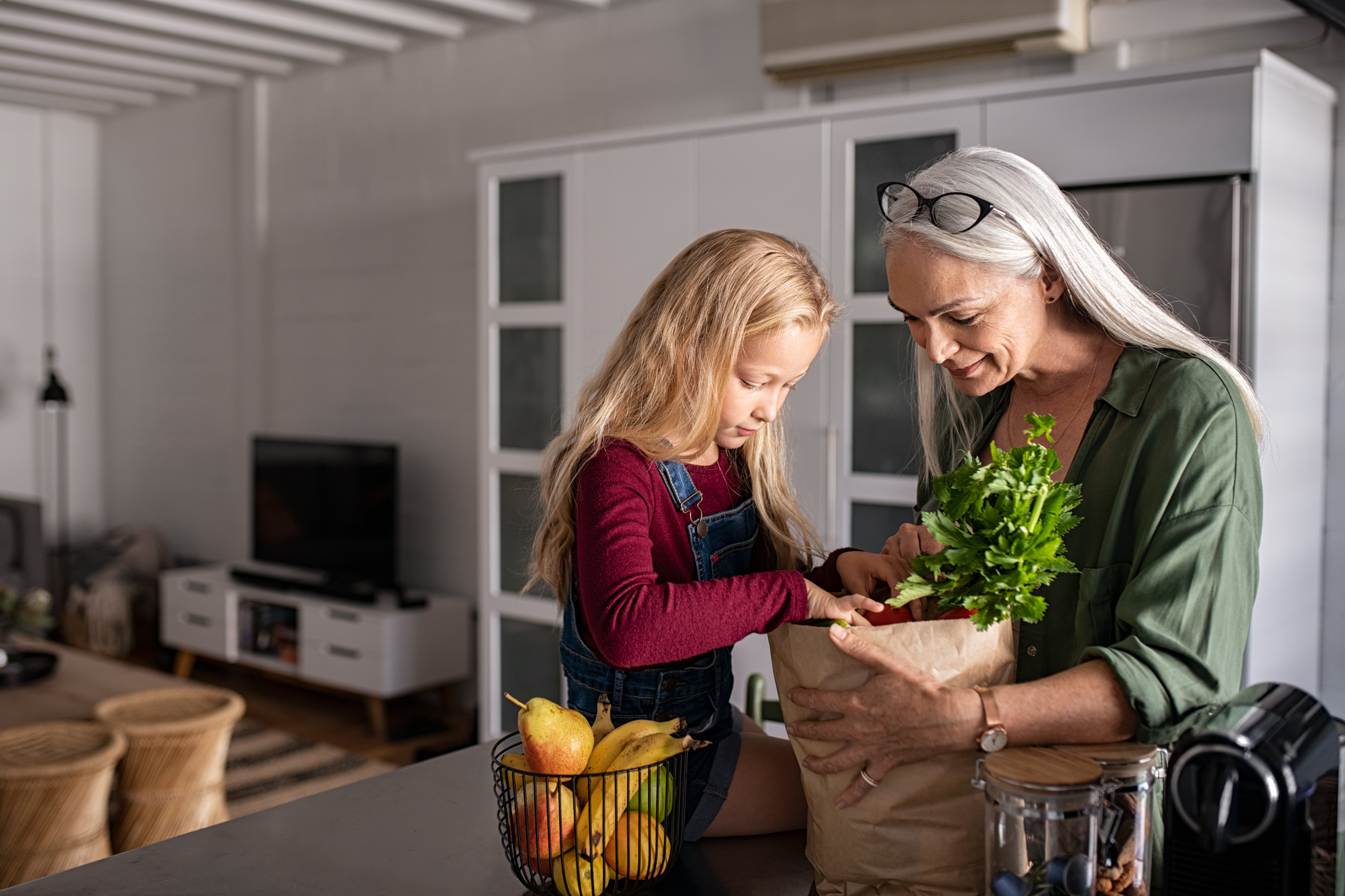 grandma-and-girl-holding-grocery-shopping-bag-2021-08-26-15-34-43-utc