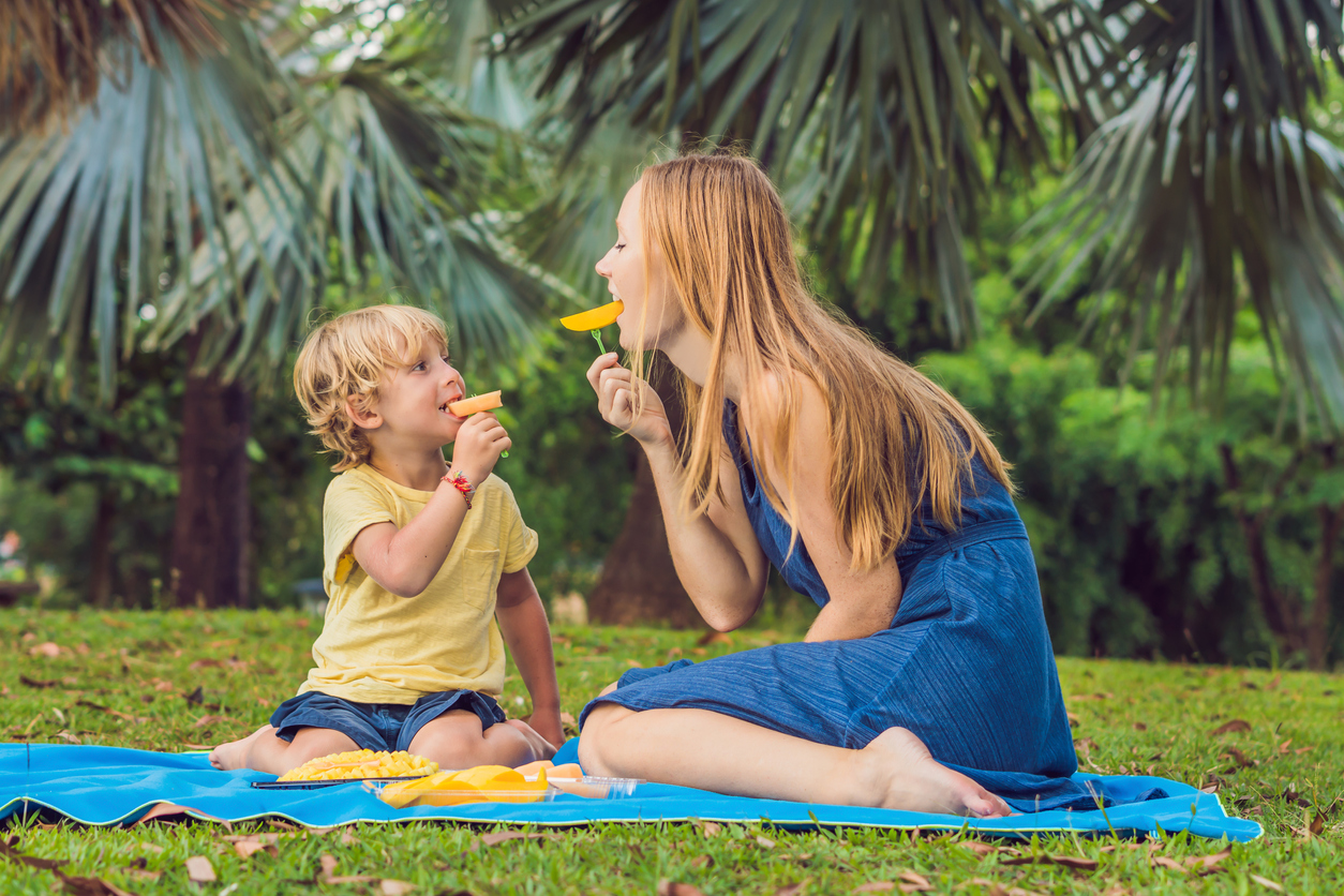 Mother and son eating mango